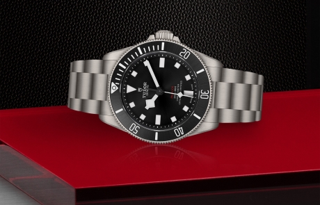 TUDOR PELAGOS laid down showcasing the black sunray satin finish with sandblasted flange and monobloc luminescent ceramic composite hour markers dial and overall elegance.