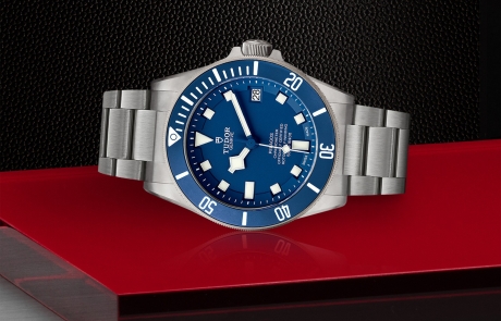 TUDOR PELAGOS laid down showcasing the blue with white index dial and overall elegance.