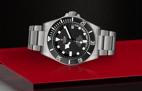 TUDOR PELAGOS laid down showcasing the black with white index dial and overall elegance.