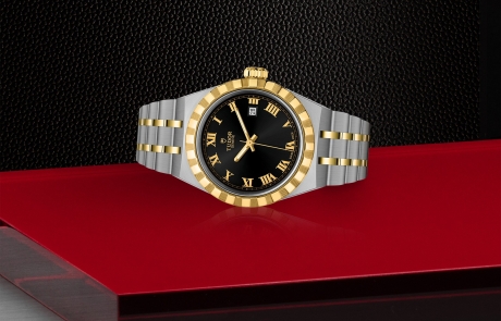 TUDOR TUDOR ROYAL laid down showcasing the black, sunray-finish dial and overall elegance.