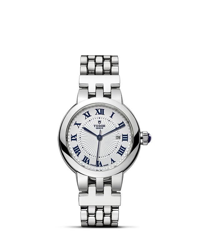 TUDOR CLAIR DE ROSE presented upright against a white grid, focusing on its refined aesthetics.