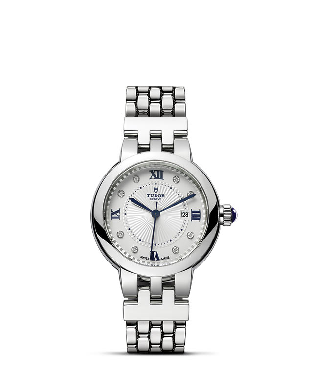 TUDOR CLAIR DE ROSE presented upright against a white grid, focusing on its refined aesthetics.