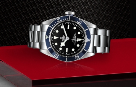 TUDOR BLACK BAY laid down showcasing the black with grey index, domed dial and overall elegance.