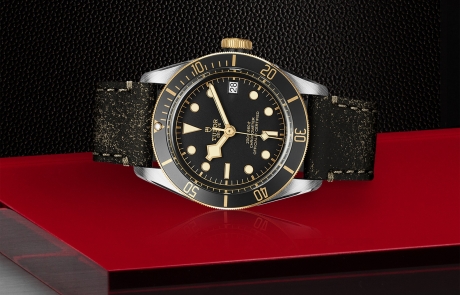 TUDOR BLACK BAY laid down showcasing the black, domed dial and overall elegance.
