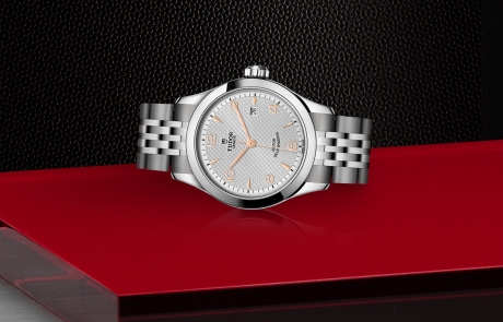 TUDOR 1926 laid down showcasing the silver, embossed decoration, domed dial and overall elegance.