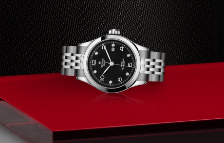 TUDOR 1926 laid down showcasing the black, embossed decoration, domed, with 6 diamonds dial and overall elegance.