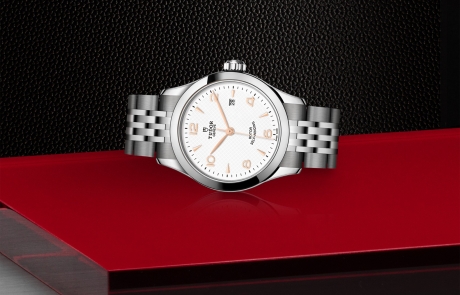 TUDOR 1926 laid down showcasing the white, embossed decoration, domed dial and overall elegance.