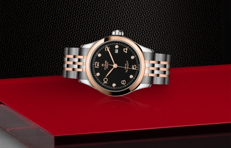 TUDOR 1926 laid down showcasing the black, embossed decoration, domed, with 6 diamonds dial and overall elegance.