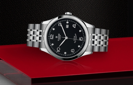 TUDOR 1926 laid down showcasing the black, embossed decoration, domed, with 6 diamonds dial and overall elegance.