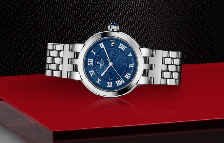 TUDOR CLAIR DE ROSE laid down showcasing the blue dial and overall elegance.
