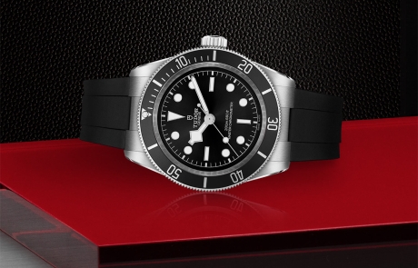 TUDOR BLACK BAY laid down showcasing the black, domed, with silver-coloured applied hour markers dial and overall elegance.