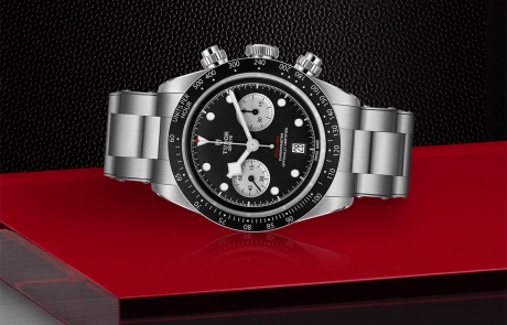TUDOR BLACK BAY CHRONO laid down showcasing the black with silver counters, domed dial and overall elegance.