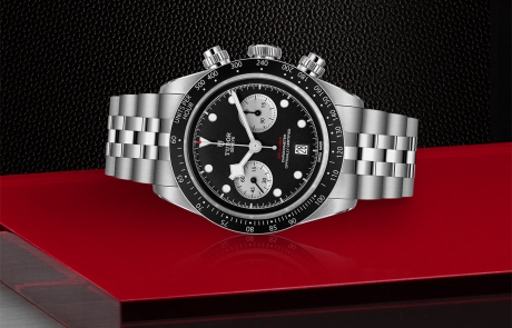 TUDOR BLACK BAY CHRONO laid down showcasing the black with silver counters, domed dial and overall elegance.