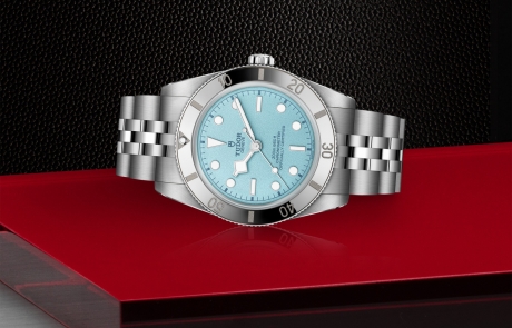 TUDOR Daring Watches laid down showcasing the blue, domed and textured dial and overall elegance.