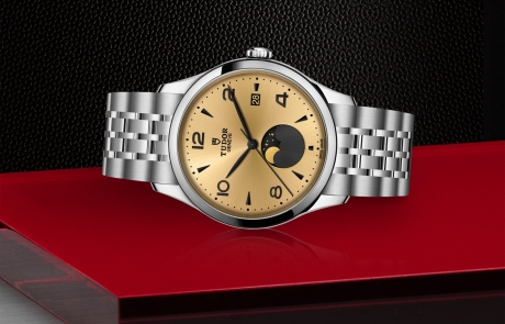 TUDOR 1926 laid down showcasing the champagne-colour satin sun-brushed dial with applied numerals and moon phase indicator dial and overall elegance.